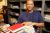 Unbound enthusiasm Norris Purdy, a 10-year employee in the U. of I. Library's shipping and receiving division, is known for the smile on his face as much as the quality work he performs. Purdy, a recent recipient of the Chancellor's Distinguished Staff Award, is responsible for receiving, sorting and delivery of books and materials throughout the University Library system. "We get to see some pretty rare things," he said.  Click photo to enlarge