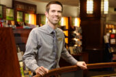 May I help you? Todd Moeglich, a clerk at the Illini Union Bookstore who recently was promoted to general merchandise manager, handles all types of store merchandise during his workday - but not books. Moeglich, a U. of I. graduate with a cinema studies degree, has 15 years retail experience and will do almost anything to ensure customers are being treated in a manner that will make them return.  Click photo to enlarge