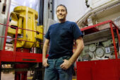 Meet the press Greg Milner, the research lab shop supervisor for the department of aerospace engineering, stands in front of the U. of I.'s universal testing machine - a giant press that can exert 3 million pounds of force, either for pushing or pulling an object to test its failure load.  Click photo to enlarge