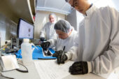 Students Dawn Haken, Jos Tuason and Osamu Miyawaki work on assembling and testing solar panels that will provide power for a CubeSat mission slated to launch in the fall.