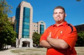 Jason Hatton stands in front of the Beckman Institute Building, where he serves as facility manager. He said the building's architectural uniqueness had stood out to him even before he became a UI employee. "I've always thought it looks impressive, and the tower is the perfect centerpiece for this part of campus."  Click photo to enlarge