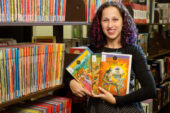 South Asian Studies librarian Mara Thacker holds some of the comics from the Undergraduate Library's collection of Indian comic books.