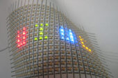 A flexible array of LEDs mounted on paper. Hand-drawn silver ink lines form the interconnects between the LEDs.