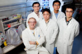 Chemistry professor Eric Oldfield (seated) with (clockwise from behind Oldfield) graduate students Jikun Li, Yi-Liang Liu and Weixue Wang and postdoctoral researcher Ke Wang developed a potent inhibitor to a chemical reaction that allows some disease-causing bacteria and the malaria parasite to survive.