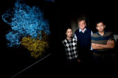 Physics professor Klaus Schulten and graduate student Leonardo Trabuco, left, and postdoctoral researcher James Gumbart, with model of a ribosome, are using the computer as a microscope to decipher the chemical details of ribosome function.