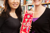 Psychology professor Eva Pomerantz, right, student Lili Qin and their colleagues found that American children's sense of obligation to their parents and desire to please them by doing well in school declined in the seventh and eighth grades, while Chinese students of the same age generally maintained their feelings of obligation and increased their motivation to please their parents with their academic achievements. Qin holds a Chinese greeting card offering the recipient good luck with academics in the new year.