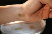 An ultrathin, electronic patch with the mechanics of skin, applied to the wrist for EMG and other measurements.