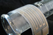 Reactive silver ink is airbrushed onto a thin, stretchy plastic film to make a flexible silver electrode.