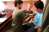 Jonathan Naber, left, and Adam Booher fit the first amputee patient with one of three prototypes Illini Prosthetic Technologies tested on a trip to Guatemala in July 2010.