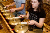 Cody Jensen, U. of I. senior in music performance, teaches Danielle Carter, senior at O'Fallon (Ill.) Township High School, how to play the reyong during an Illinois Summer Youth Music camp at the Robert E. Brown Center for World Music in the School of Music.