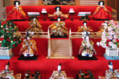 Hina dolls are presented in a carefully arranged display, with dolls representing the Emperor and Empress, court attendants, musicians, ministers and samurai.