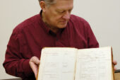 John Marlin, a research affiliate with the Illinois Sustainable Technology Center and Illinois Natural History Survey, displays one of Charles Robertson's original accession books in which he recorded data about the more than 25,000 insects he collected in Carlinville, Ill.