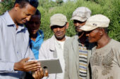 Gemechu Olana, a professor at Adama Science and Technology University, left, shares SAWBO animations with Ethiopian farmers.