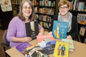 Deborah Stevenson, left, editor of The Bulletin of the Center for Children's Books and director of the Center, and Kate Quealy-Gainer, assistant editor of the Bulletin, with some of the books featured in the 2014 Guide Book to Gift Books. The guide offers suggestions of books to give to children.