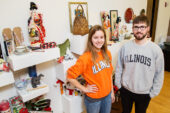 University of Illinois students Christine Kausal, a junior majoring in global studies and communication, and Tom McCormick, a sophomore majoring in architecture, with some of the donated items for sale at the Japan House Pop-Up Holiday Bazaar. Kausal and McCormick are interns at the Japan House. The bazaar benefits the internship program.