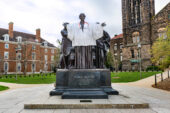 The Alma Mater statue wearing a Carle Illinois College of Medicine white coat