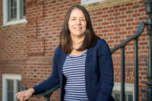 Journalism lecturer Nancy Averett stands on the outdoor stairs of Gregory Hall on the University of Illinois Urbana-Champaign campus.