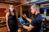 Graduate student Jonathan Cerna monitors heart data from a “smart shirt” that tracks electrical activity as graduate student Laila Shaaban exercises and rests.