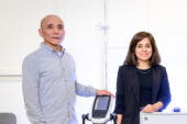 The researchers standing with a scale.