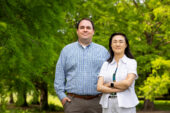 Portrait of the researchers standing outside in front of a grove of trees.