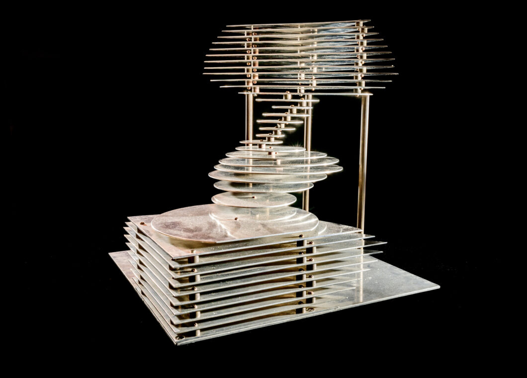 Photo of an aluminum model made of a series of cascading circles.