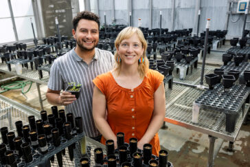 portrait of Ivan Sosa Marquez and Katy Heath in a greenhouse.