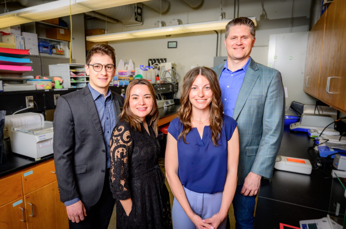 The U. of I. team standing in the lab