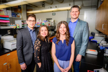 The U. of I. team standing in the lab