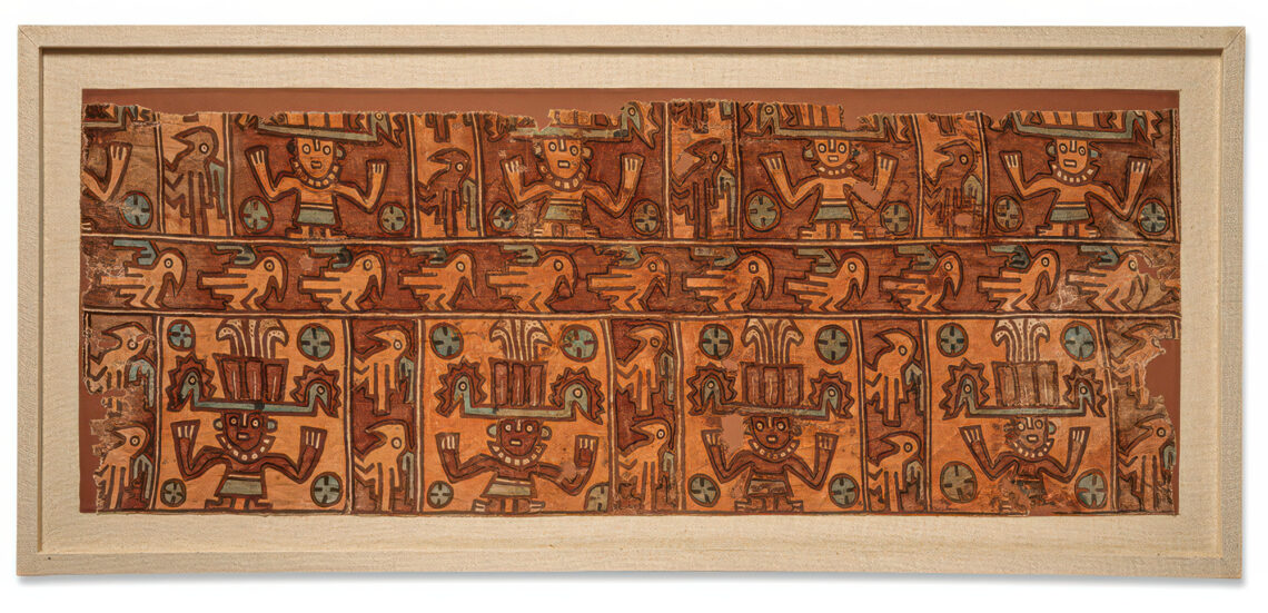 Image of a fragment of a woman's dress in orange and rust tones, with Andean images of birds and of people wearing headdresses.