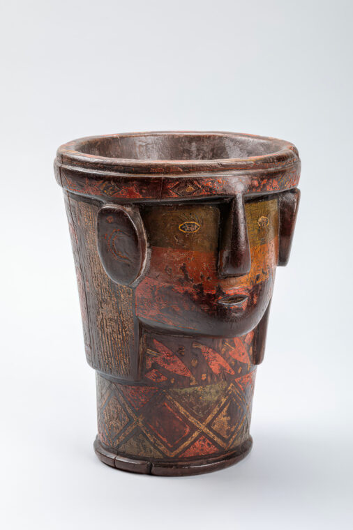 Photo of a wooden cup with a face on it from Peru.