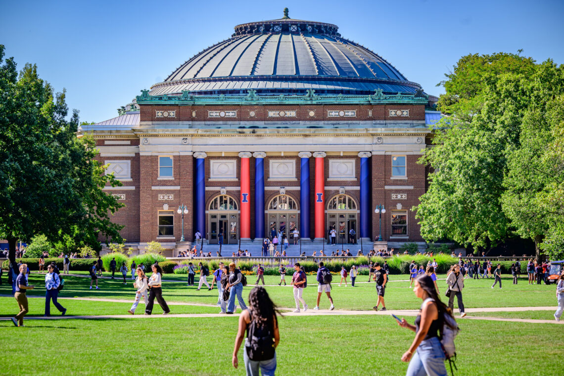 Students cross the Main Quad near Foellinger Auditorium at the University of Illinois Urbana-Champaign.