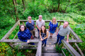 Research team stands on a observation deck in Busey Woods.
