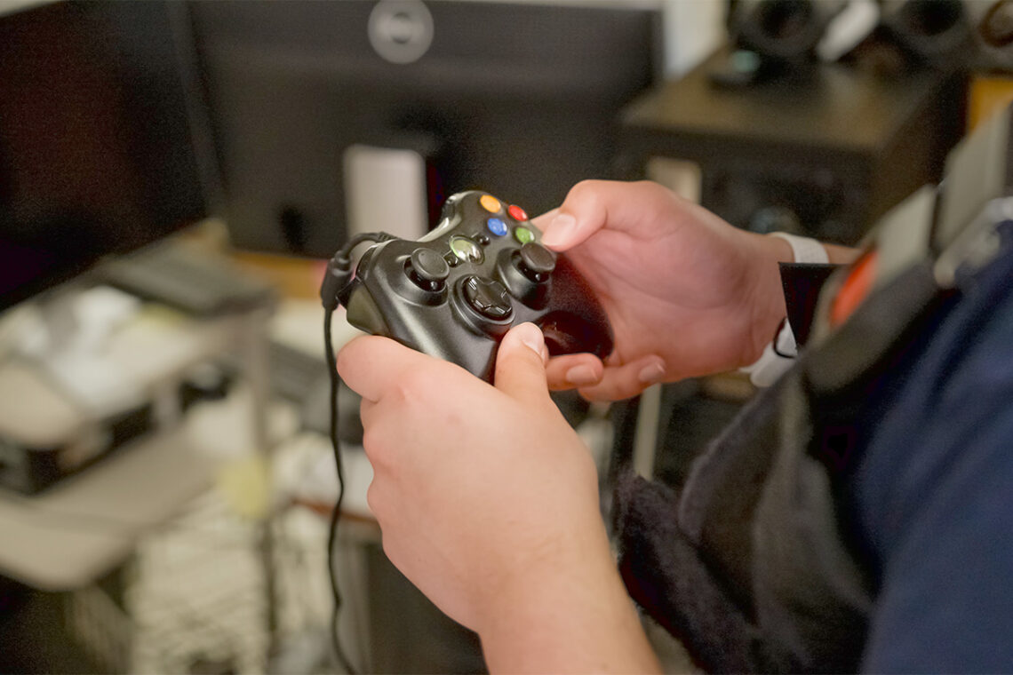 Closeup of what looks like a standard video game controller in the participant's hands