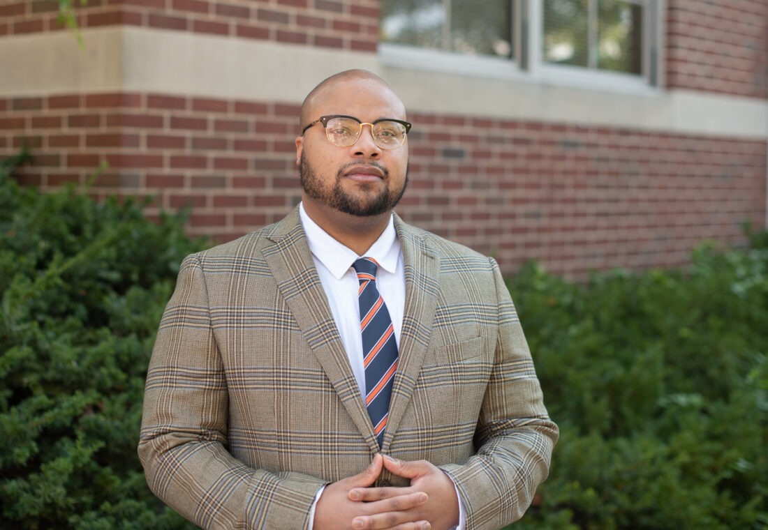 Cortney VanHook standing outside the School of Social Work building