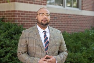 Cortney VanHook standing outside the School of Social Work building