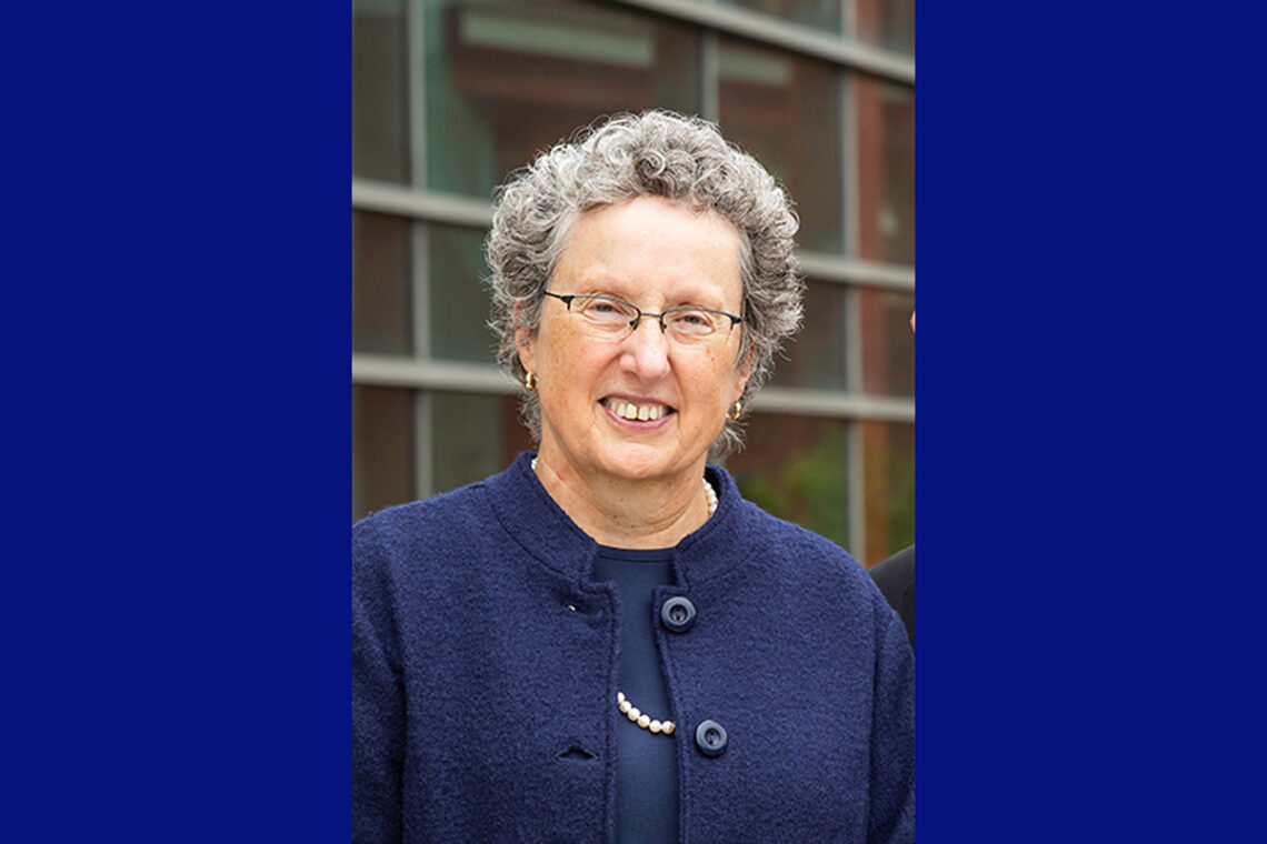A woman with glasses wearing dark blue