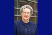 A woman with glasses wearing dark blue
