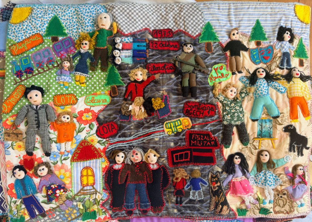 Photo of an arpillera showing various scenes from the artist's life.