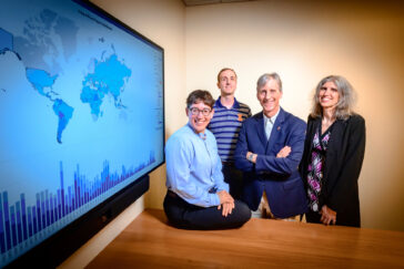 Photo of Cline Center researchers. From left, Emmy Tither, a PhD candidate in Informatics at Illinois; Joseph Bajjalieh, a senior research manager at the Cline Center; Scott Althaus, the director of the Cline Center and the Merriam Professor of Political Science at Illinois; and Loretta Auvil, a senior project coordinator at the National Center for Supercomputing Applications and a data scientist at the Cline Center.