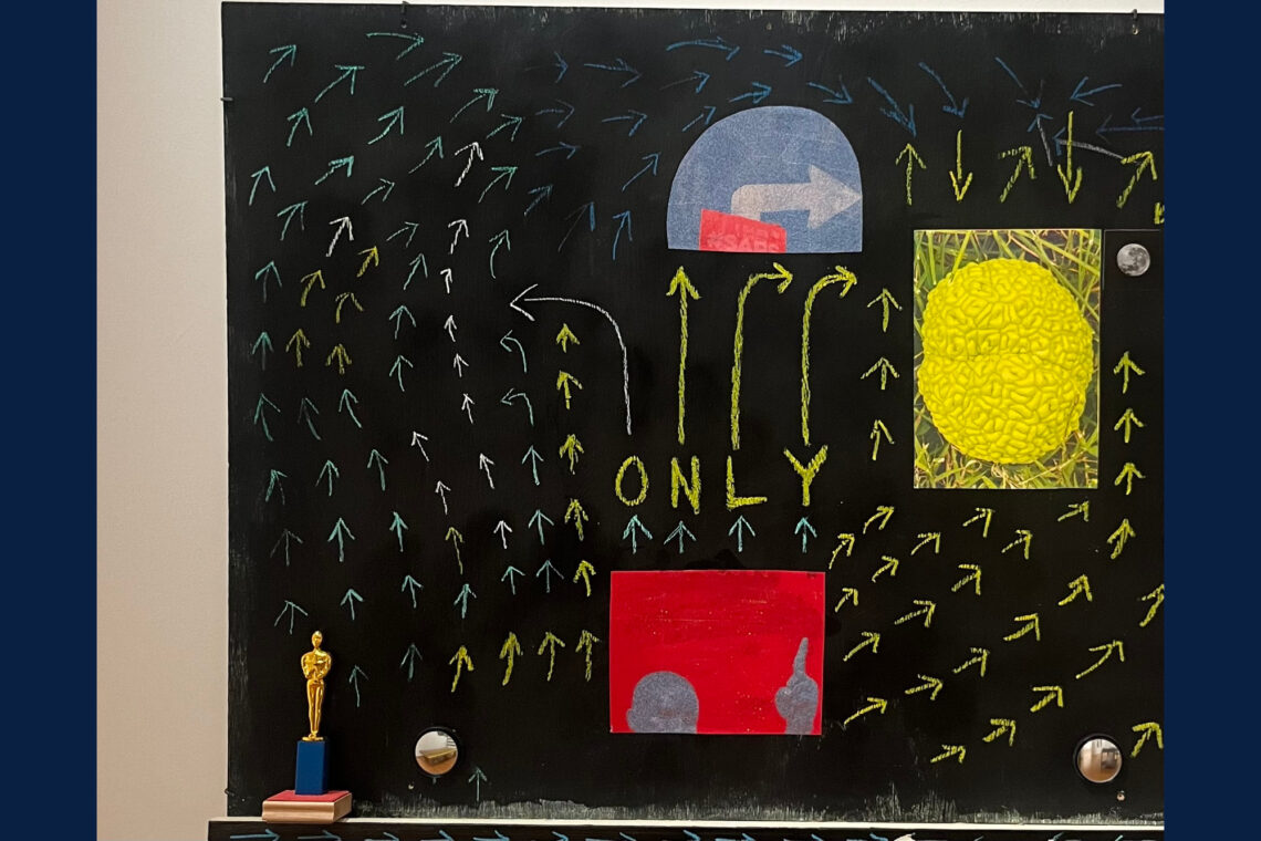 Photo of a blackboard painted with arrows and other colorful imagery.