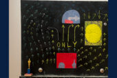 Photo of a blackboard painted with arrows and other colorful imagery.