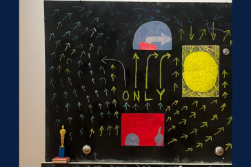 Photo of a blackboard painted with arrows and other colorful imagery.