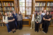 Photo of a group of students in the Ricker Library of Architecture and Art, in front of a windowsill with an exhibit of architectural models.