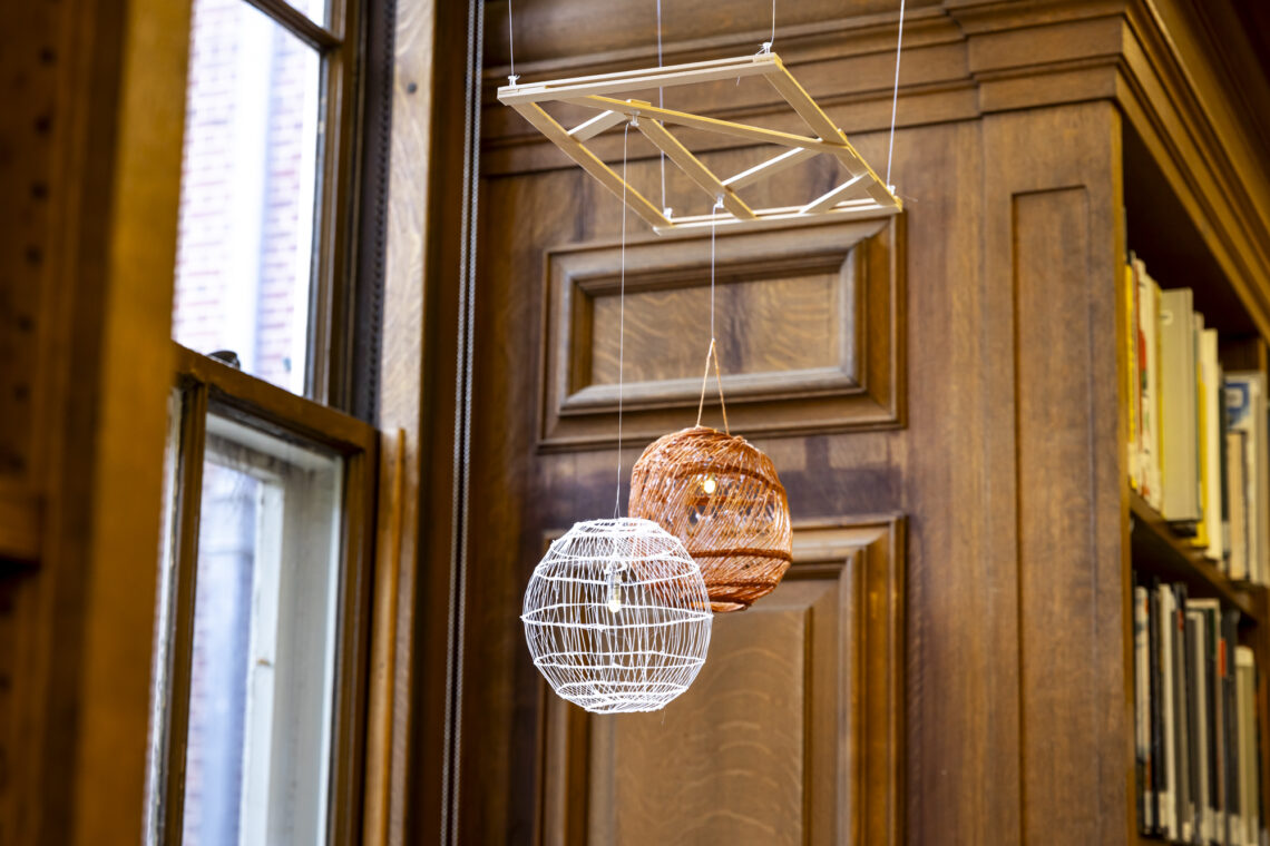 Photo of models of woven lamps hanging in the Ricker Library of Architecture and Art.