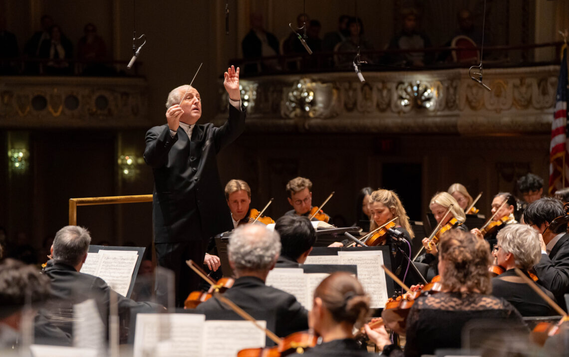 Photo of a conductor and musicians from the Pittsburgh Symphony Orchestra performing.