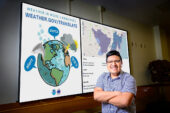Researcher portrait standing in front of graphics from study