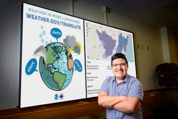 Researcher portrait standing in front of graphics from study