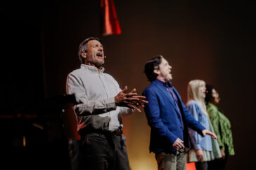 Photo of four people singing, with Nathan Gunn in the foreground.