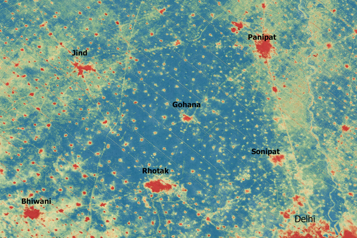 The image shows a satellite image comparing the differences in temperature found in cities and rural areas in India. Red spots mark hot areas, blue indicates cooler areas.