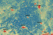 The image shows a satellite image comparing the differences in temperature found in cities and rural areas in India. Red spots mark hot areas, blue indicates cooler areas.